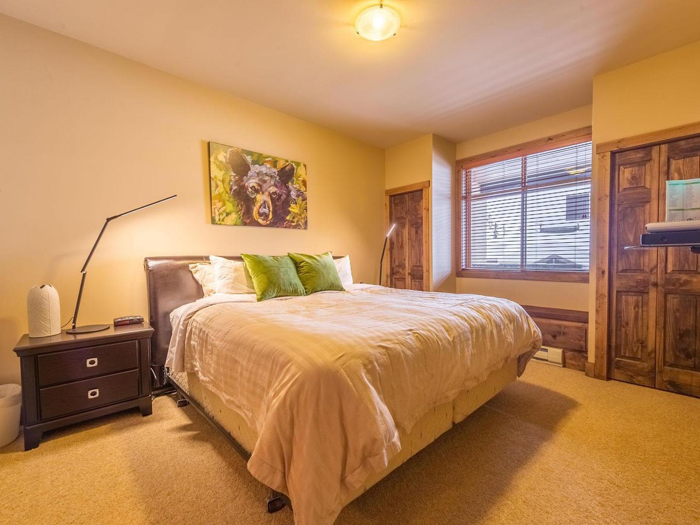 South Point 22 bedroom with a comfortable bed and bright lighting in a luxury vacation rental managed by Luxury Mountain Vacation Rentals at Big White Ski Resort.