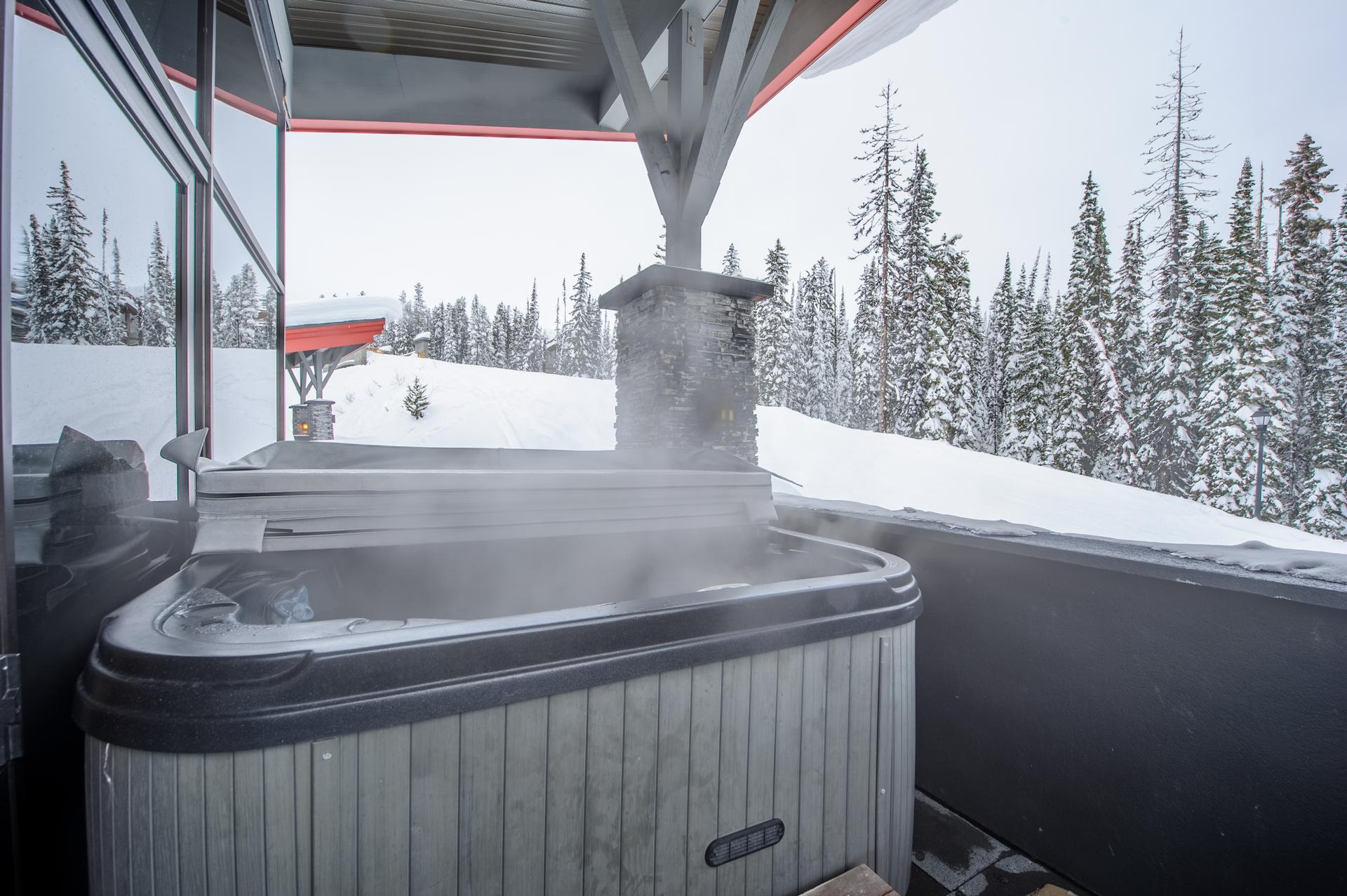 The cozy outdoor private hot tub at The Edge 5 one of Luxury Mountain Vacation Rentals' luxury properties at Big White Ski Resort.