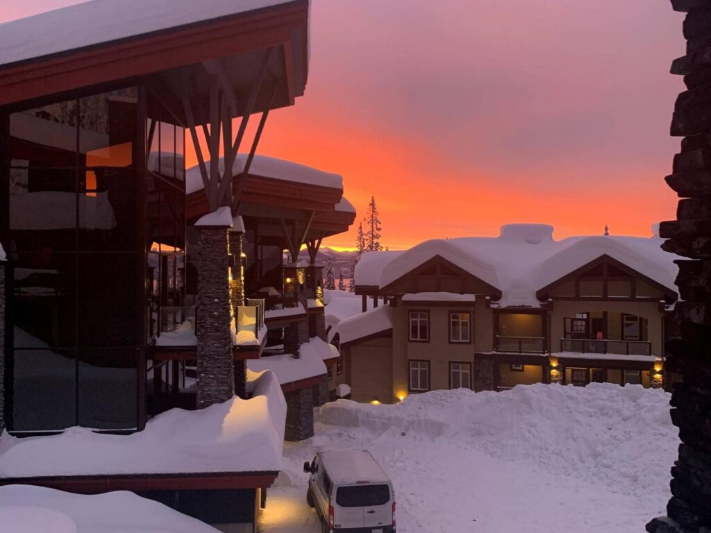 The stunning luxury vacation rental properties at Big White Ski Resort managed by Luxury Mountain Vacation Rentals and covered by thick layers of champagne powder snow at sunset, perfect for ski-in/ski-out access on a ski vacation.