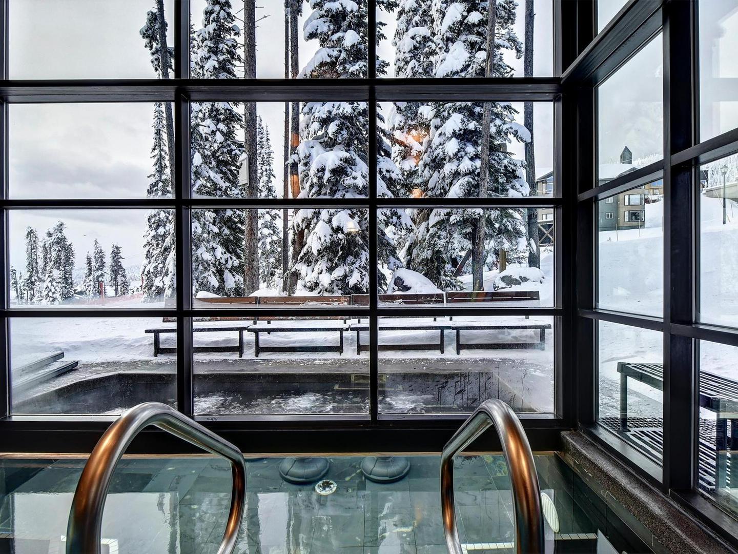A half outdoor half indoor jacuzzi hot tub in one of Luxury Mountain Vacation Rentals' luxury properties at Big White Ski Resort.