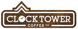 The Clocktower co logo in white and brown with a fake wood pattern. 