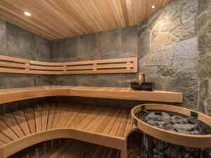 A luxury sauna room with wood panels and artisan stonework, at one of Luxury Mountain vacation Rentals' luxury accommodation at Big White Ski Resort.