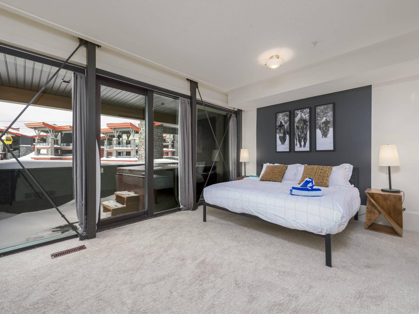 The luxury master king bedroom with modern luxury finishes and large windows in the Edge #3 at Big White Ski Resort.