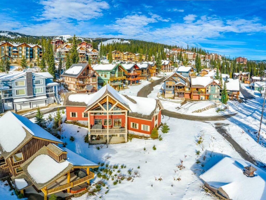 View of the many luxury chalets and lodges up on Big White Ski Resort, covered in snow