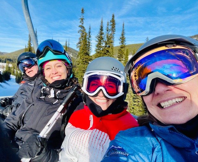 Four of the Luxury Mountain Vacation Rentals staff take a selfie while out skiing on the slopes of Big White Ski Resort.