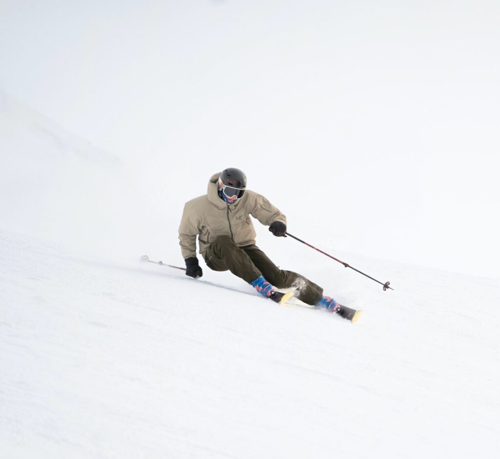 A man downhill skiing at Blackcomb Glacier at Whistler Blackcomb Ski Resort.