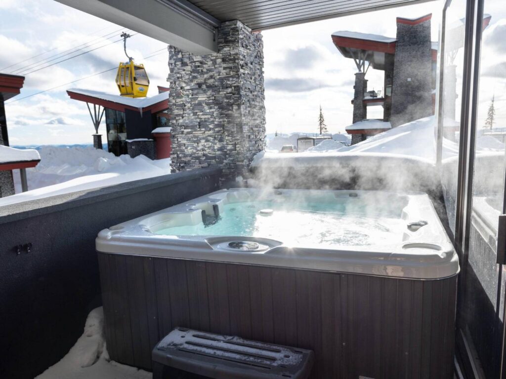 A 6 person private hot tub on the deck of one of The Edge luxury vacation rentals at Big White.