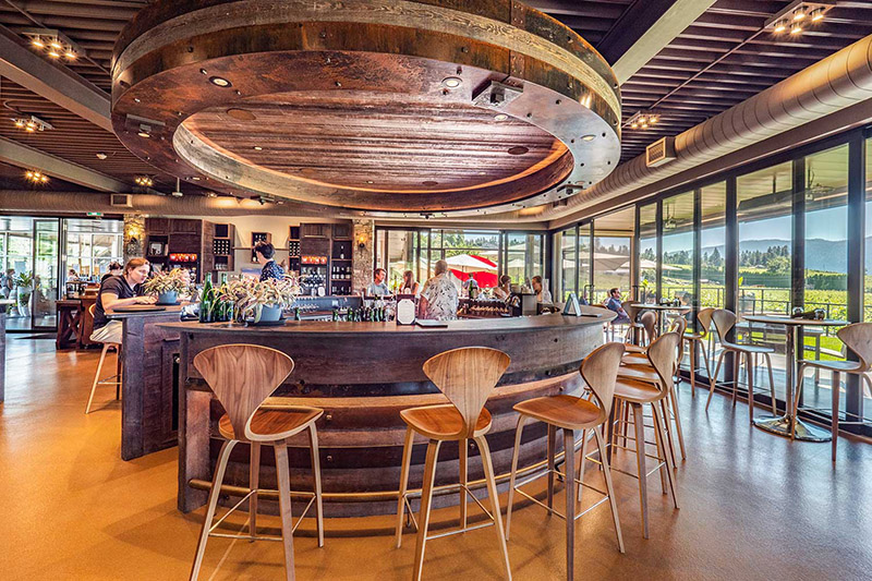 The gorgeous tasting room at Peak Cellars with a circular wood bar and chairs.